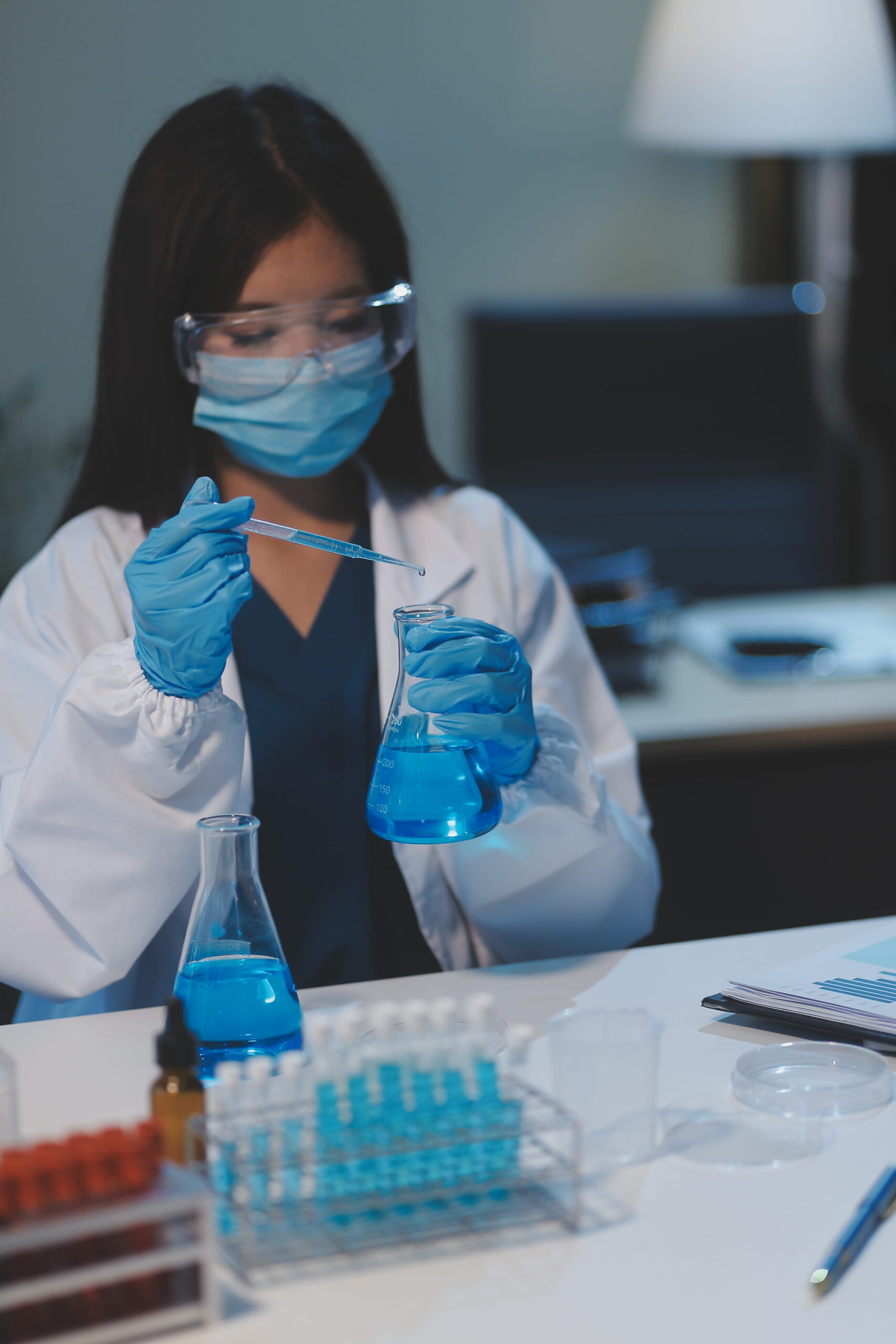 Group dedicated scientist conduct chemical experiment medical laboratory carefully drop precise amount liquid from pipette into test tube vaccine drug antibiotic development neoteric 1 scaled